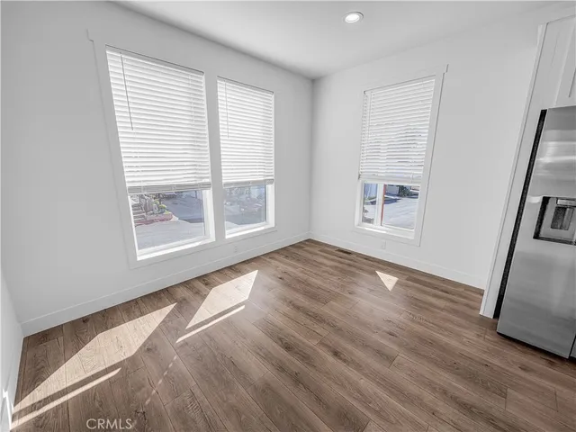 a view of kitchen with furniture and wooden floor