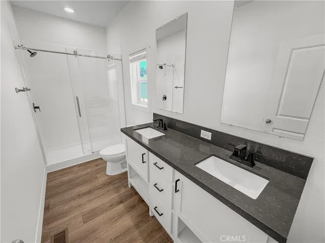 a bathroom with a double vanity sink and mirror