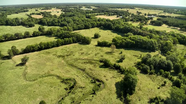 an aerial view of a houses with a lake view