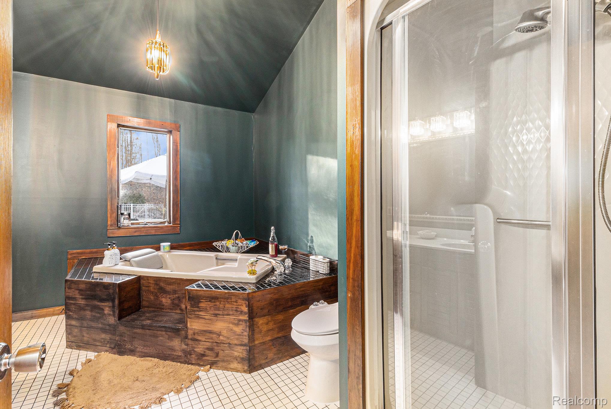 14017 North Belsay Road Millington, MI 48746 - Photo 11 of 43 Full bath featuring a shower stall, a garden tub, and tile patterned flooring