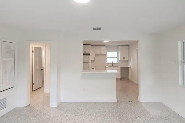 a view of a kitchen and an entryway and a kitchen