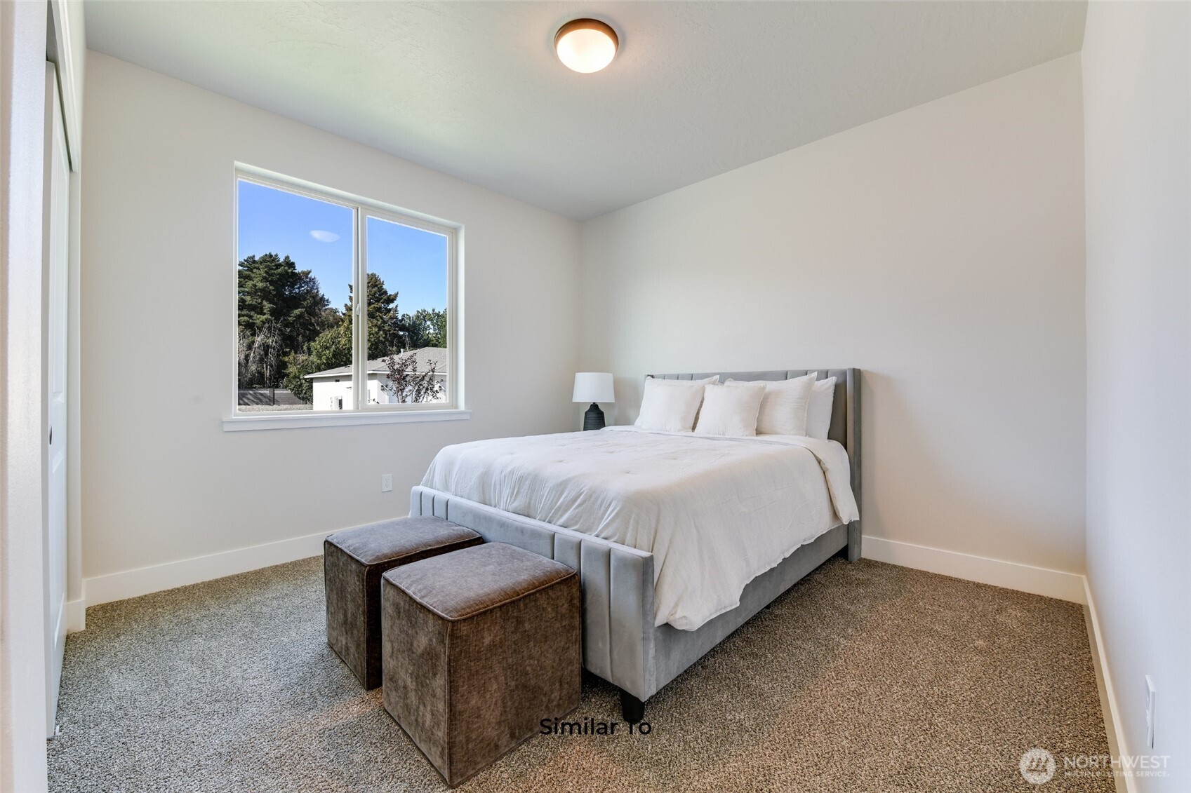 523 North Lessor Loop Moses Lake, WA 98837 - Photo 12 of 25 a bedroom with a bed and a window