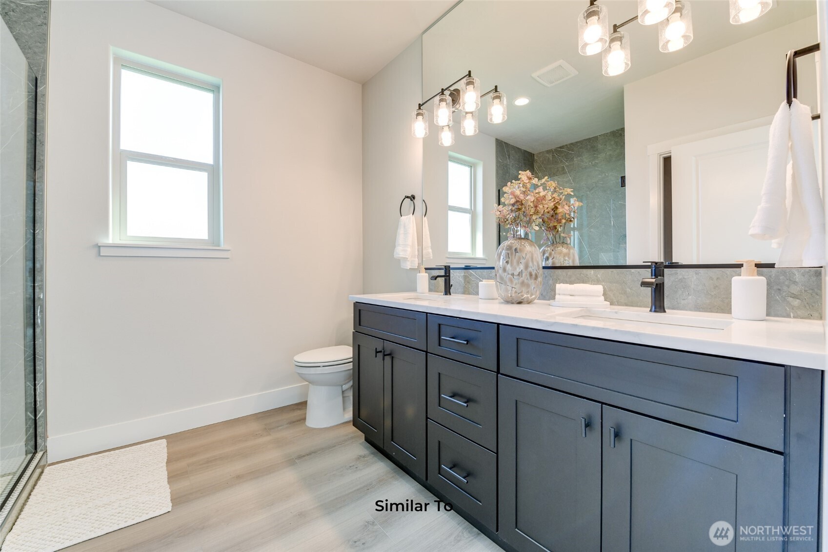 523 North Lessor Loop Moses Lake, WA 98837 - Photo 19 of 25 a bathroom with a granite countertop sink a toilet and a mirror