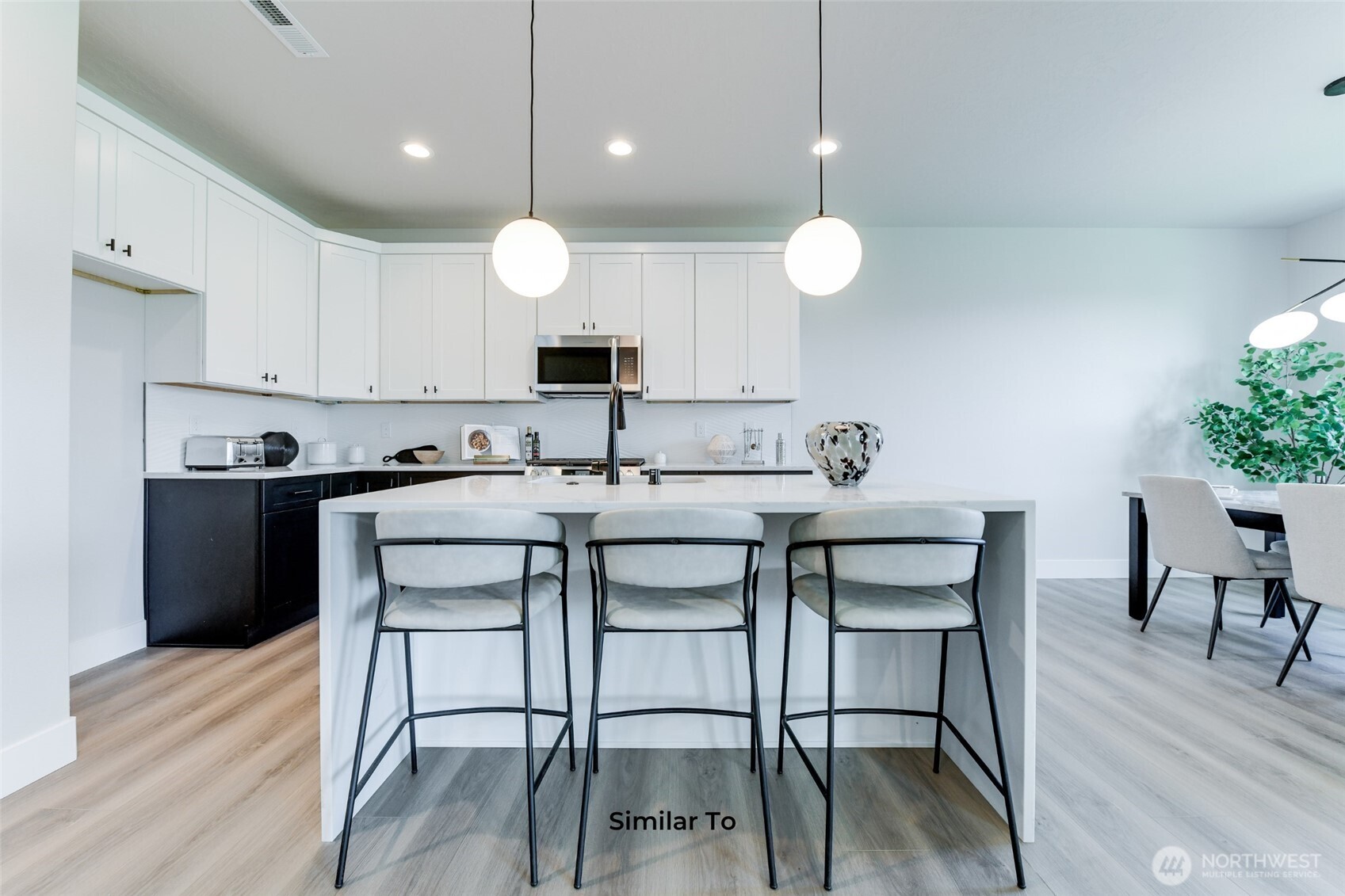 523 North Lessor Loop Moses Lake, WA 98837 - Photo 7 of 25 a kitchen with a dining table chairs sink and cabinets