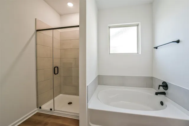 a bathroom with a bathtub and shower