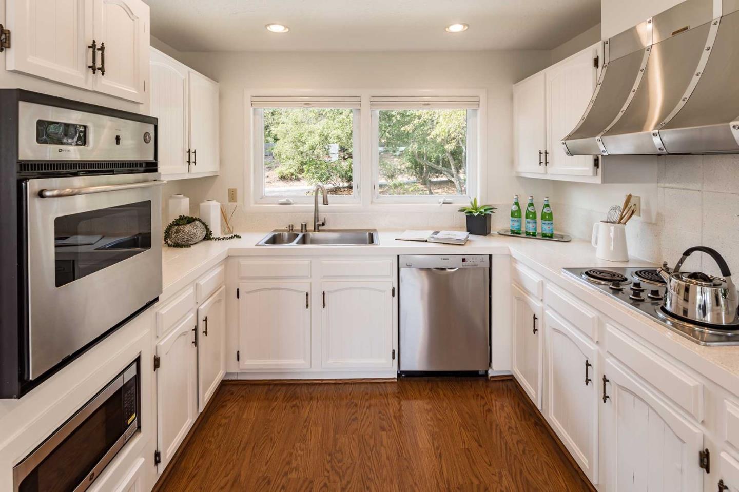 130 Hardwick Road Woodside, CA 94062 - Photo 10 of 25 a kitchen with a sink stove top oven and cabinets