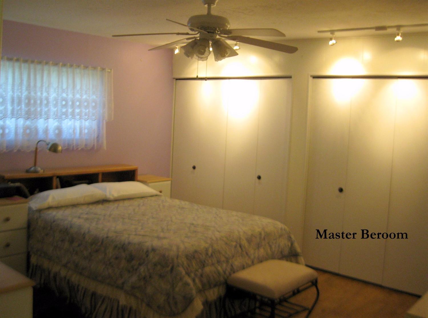6710 North Applegate Road Grants Pass, OR 97527 - Photo 13 of 33 a bedroom with a bed and a table in it