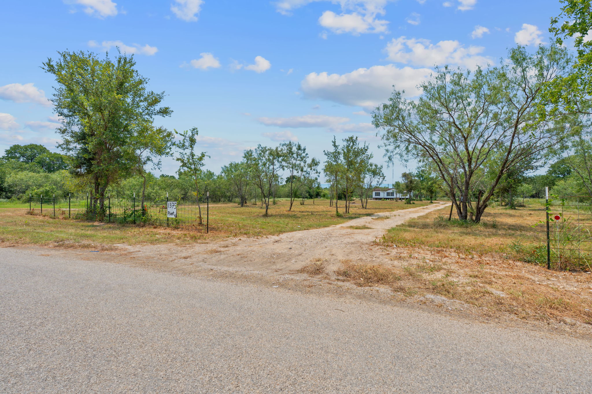 1375 Plant Road Luling, TX 78648 - Photo 14 of 17 a view of a house with a big yard and large trees