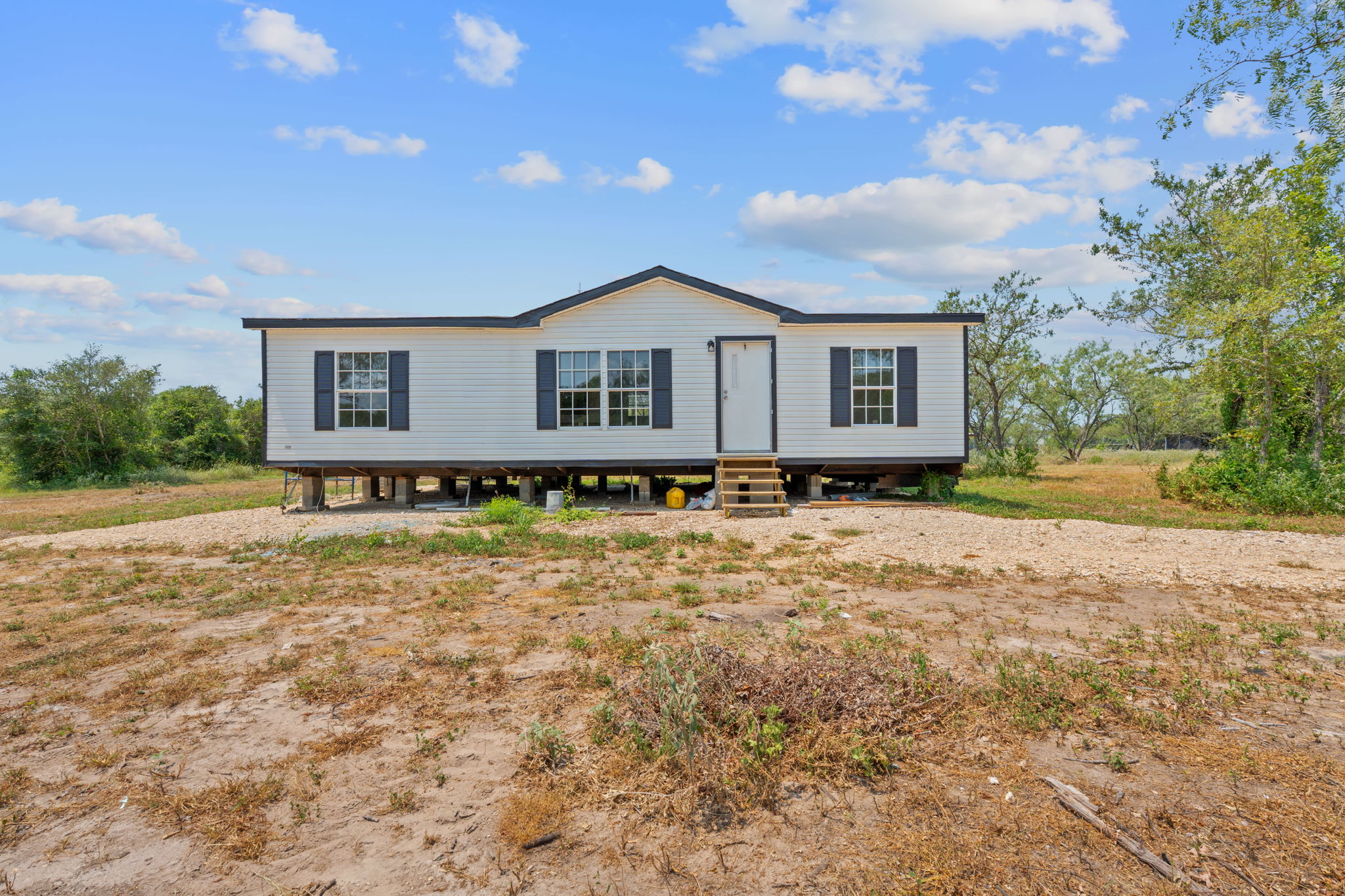 1375 Plant Road Luling, TX 78648 - Photo 2 of 17 a house with trees in the background
