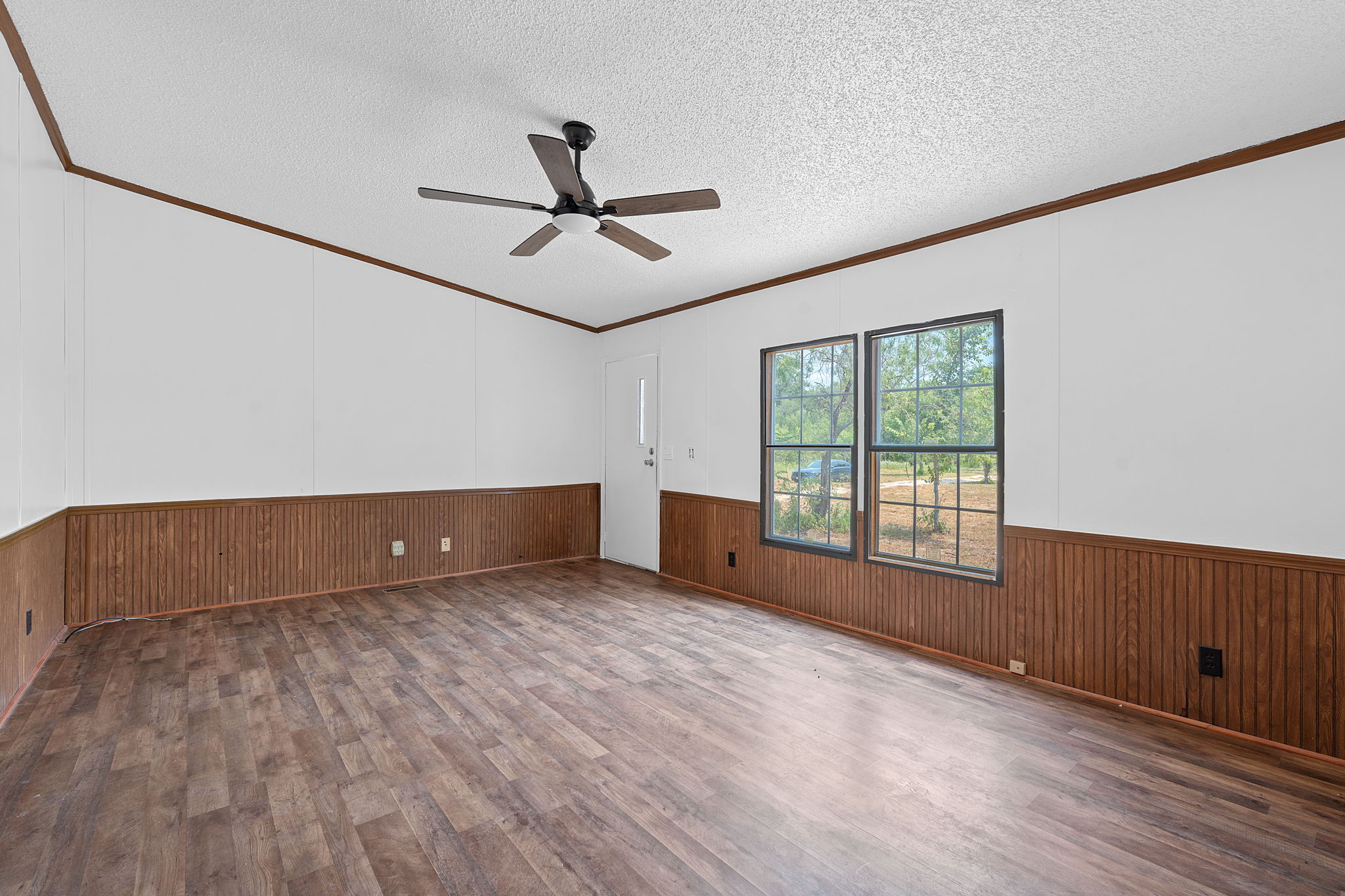 1375 Plant Road Luling, TX 78648 - Photo 4 of 17 a view of an empty room with a window and wooden floor