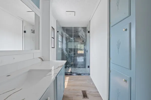 a bathroom with a sink a toilet and shower