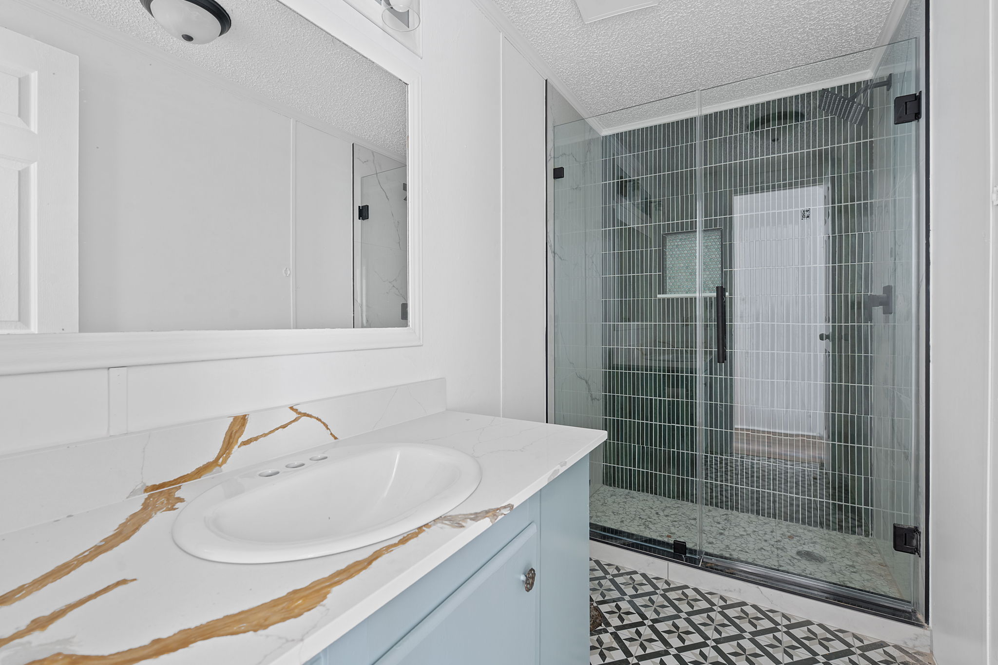 1375 Plant Road Luling, TX 78648 - Photo 10 of 17 a bathroom with a shower sink and mirror