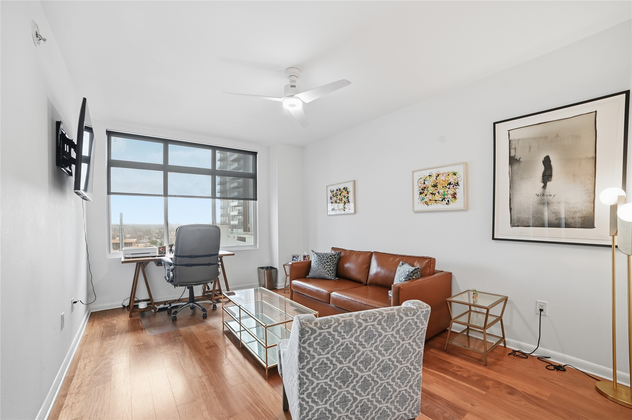 54 Rainey Street, Unit 1018 Austin, TX 78701 - Photo 23 of 32 a work room with furniture and wooden floor