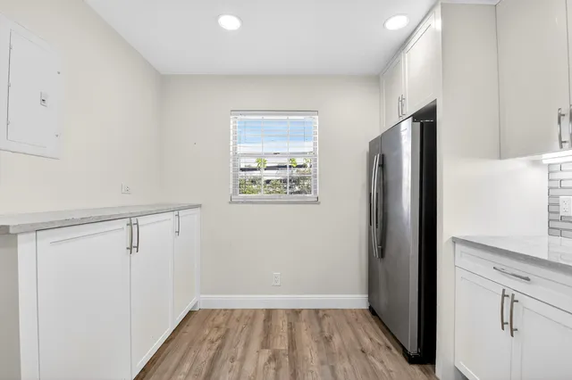 a view of hallway with wooden floor and staircase