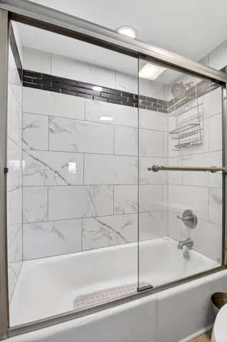 a bathroom with a bathtub and shower