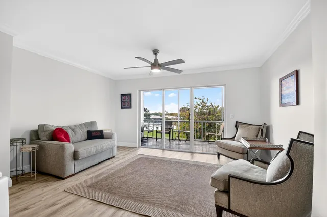 a living room with furniture and a floor to ceiling window
