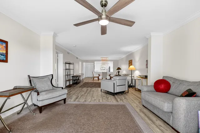a living room with furniture and a chandelier