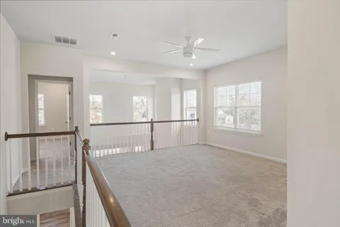 a kitchen with kitchen island a sink stainless steel appliances and refrigerator
