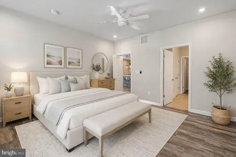 a bedroom with bed and a potted plant