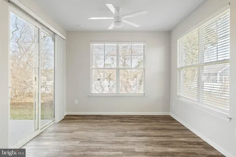 a living room with furniture a flat screen tv and a large window