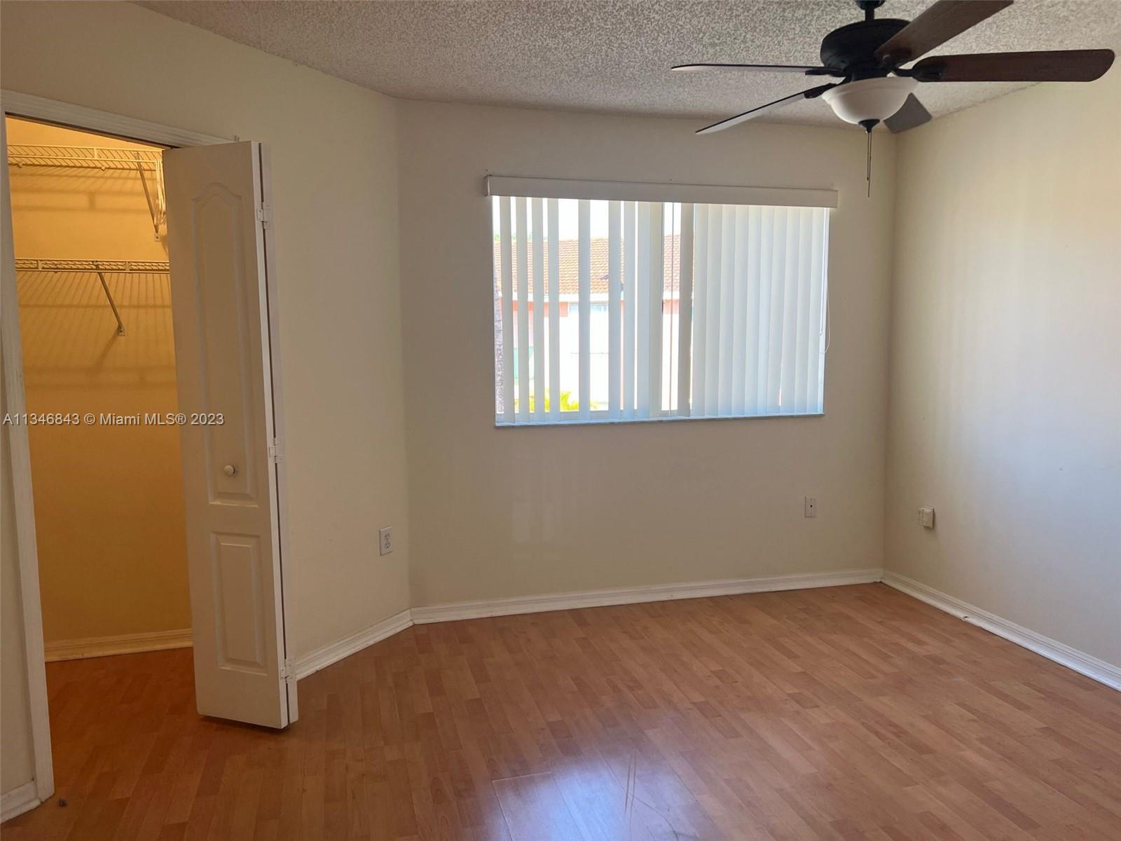 Flagami Miami, FL 33126 - Photo 11 of 14 an empty room with wooden floor closet and windows