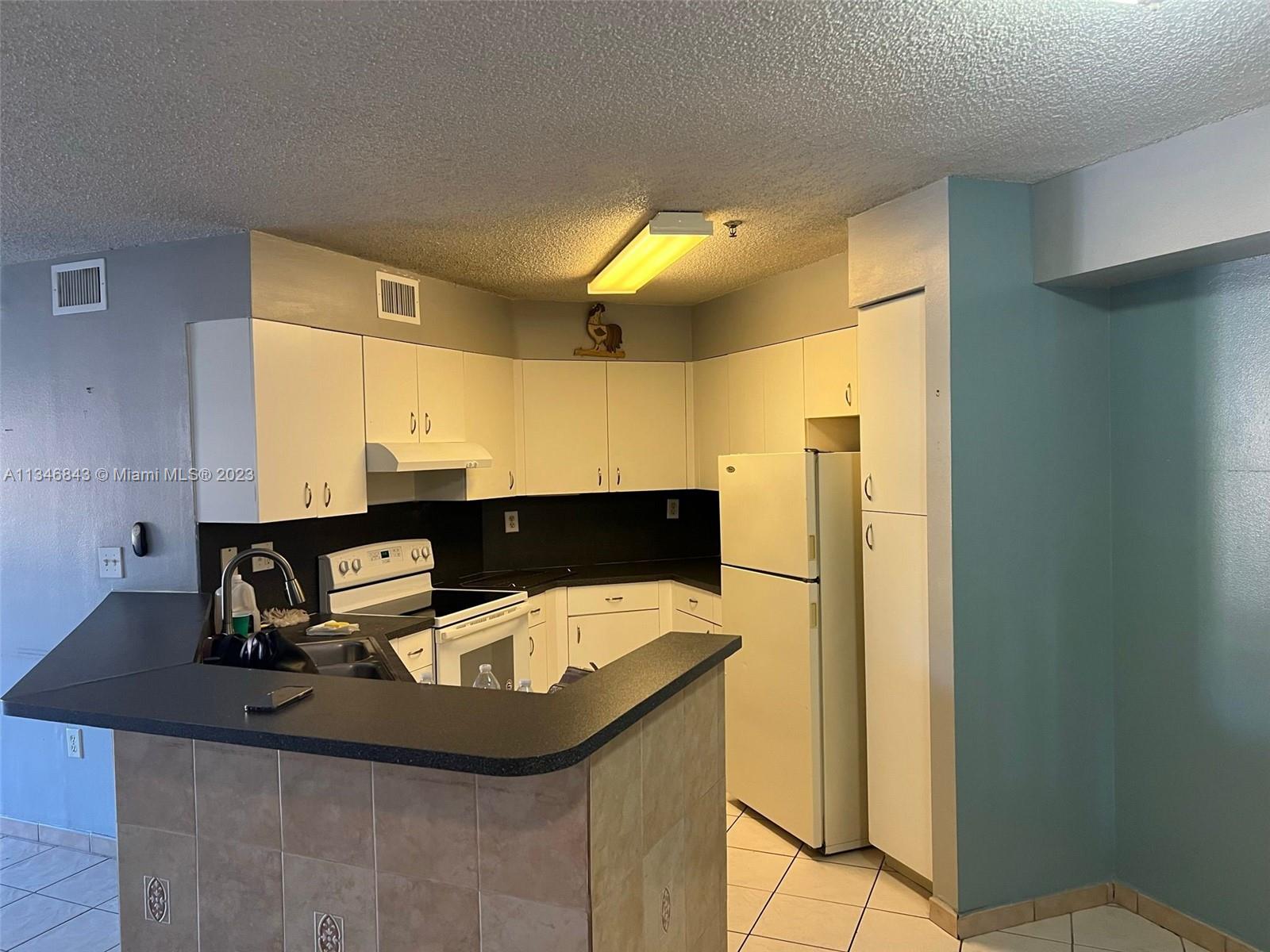 Flagami Miami, FL 33126 - Photo 6 of 14 a kitchen with a sink and a refrigerator