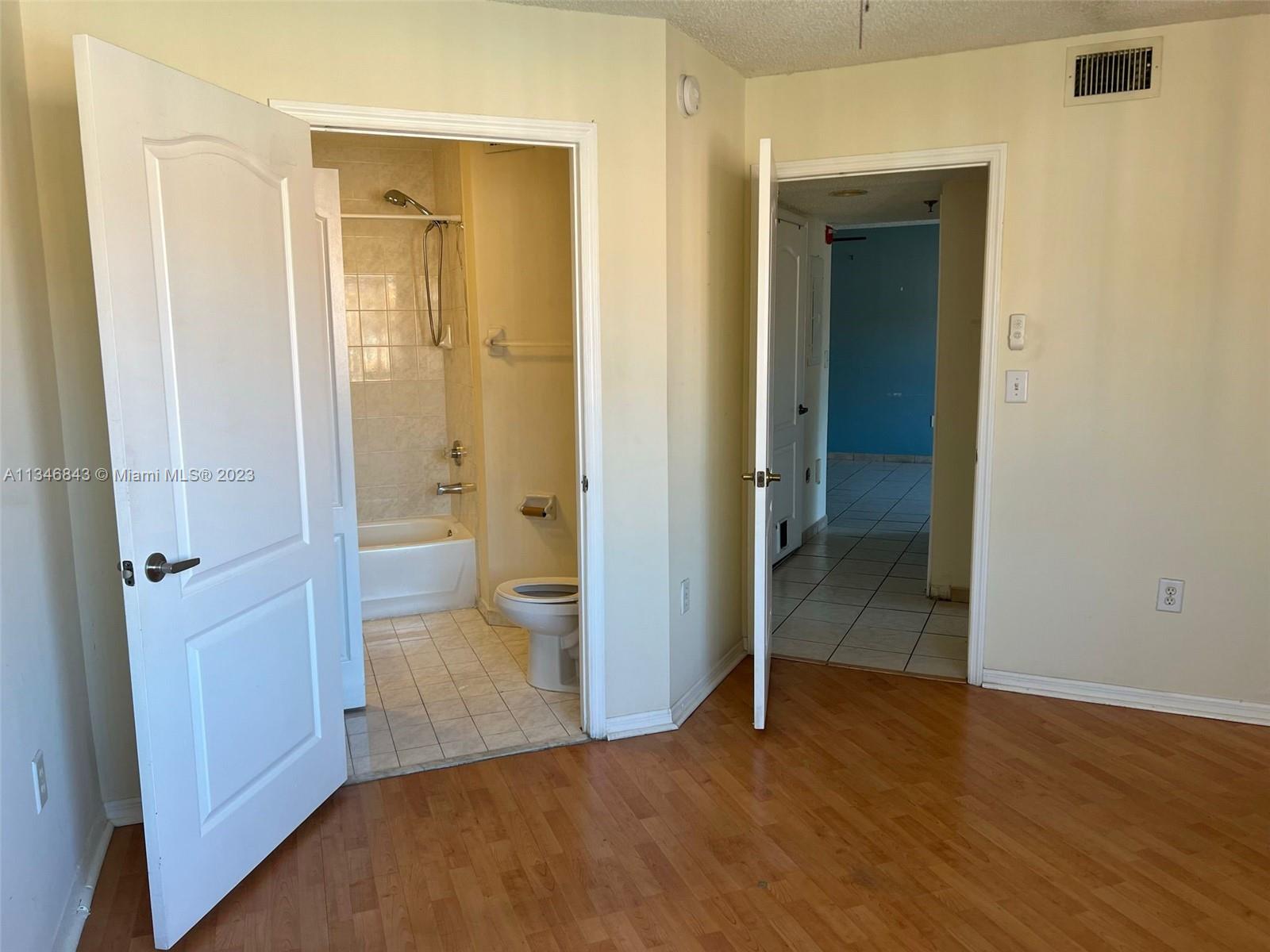 Flagami Miami, FL 33126 - Photo 9 of 14 wooden floor and closet in a bathroom