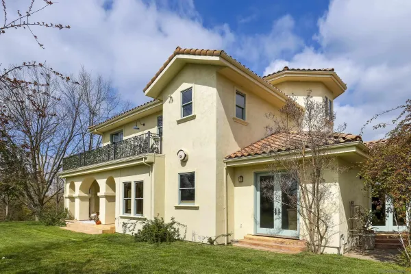 a front view of a house with a garden