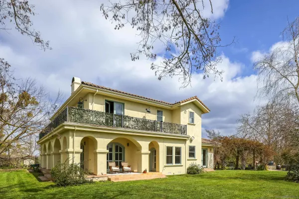an aerial view of a house with garden space and lake view