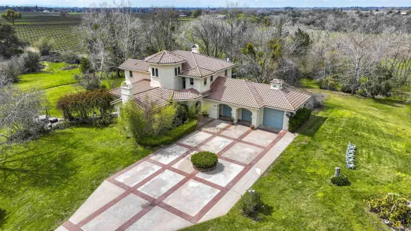 a view of a dining room with furniture large windows and wooden floor