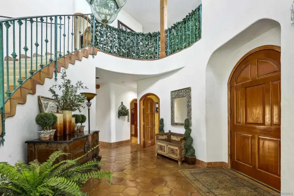 a living room with furniture a clock and a fireplace