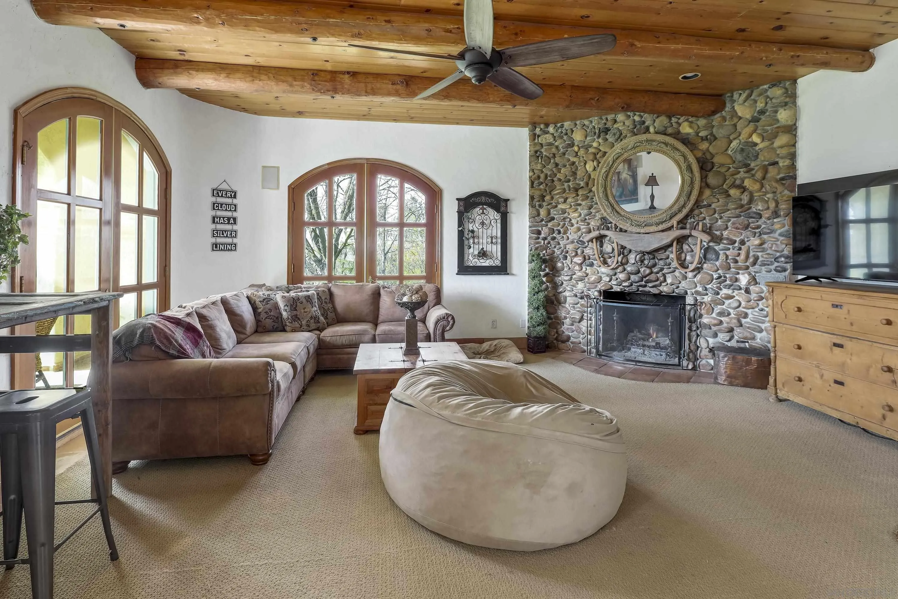 24943 North Mcintire Road Clements, CA 95227 - Photo 50 of 68 a living room with furniture a clock and a fireplace