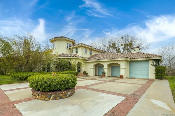 a front view of a house with a yard table and chairs