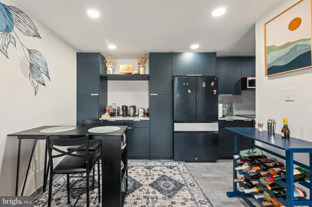 a kitchen with stainless steel appliances kitchen island granite countertop a sink and cabinets