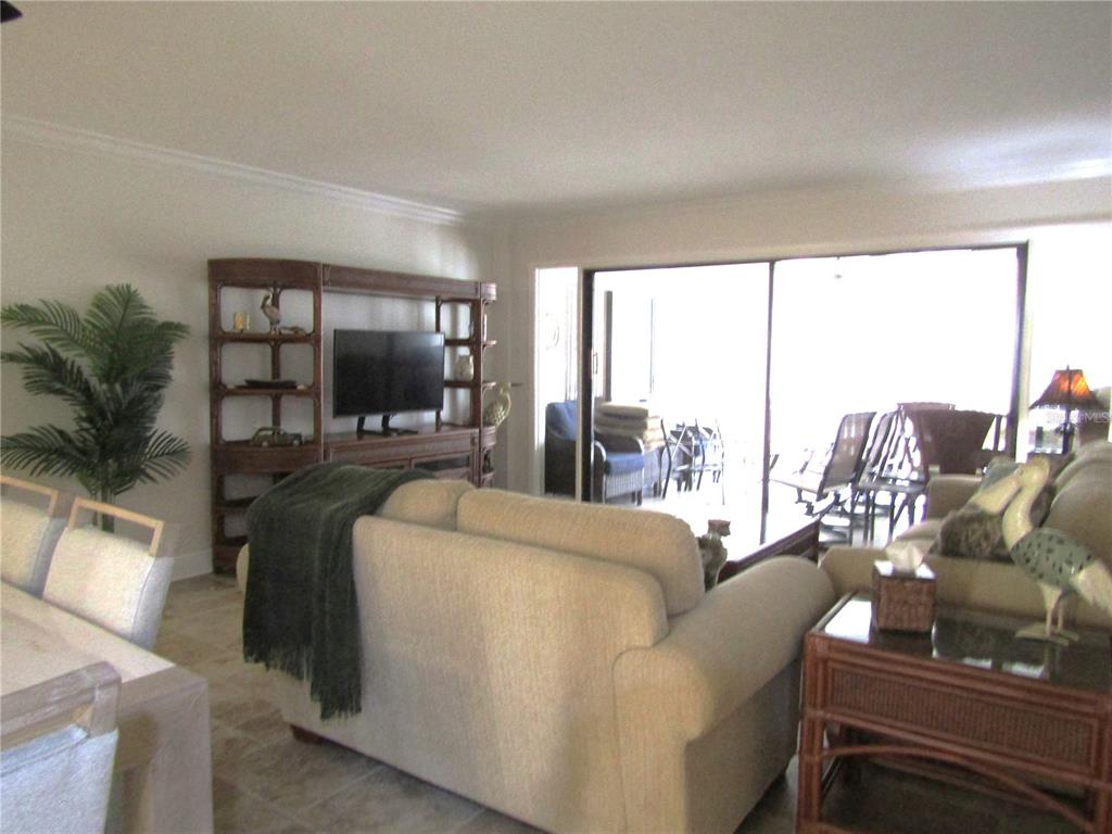 5056 Marsh Field Road, Unit 7 Sarasota, FL 34235 - Photo 15 of 31 a living room with furniture and a flat screen tv