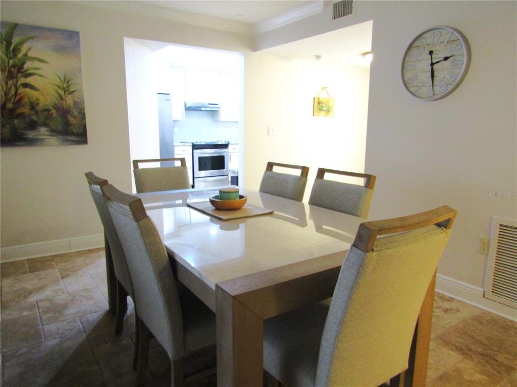 5056 Marsh Field Road, Unit 7 Sarasota, FL 34235 - Photo 17 of 31 a view of a dining room with furniture and wooden floor