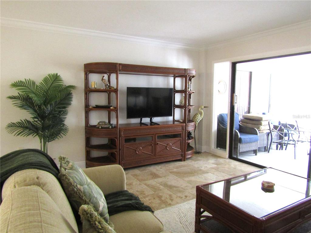5056 Marsh Field Road, Unit 7 Sarasota, FL 34235 - Photo 19 of 31 a living room with furniture and a flat screen tv
