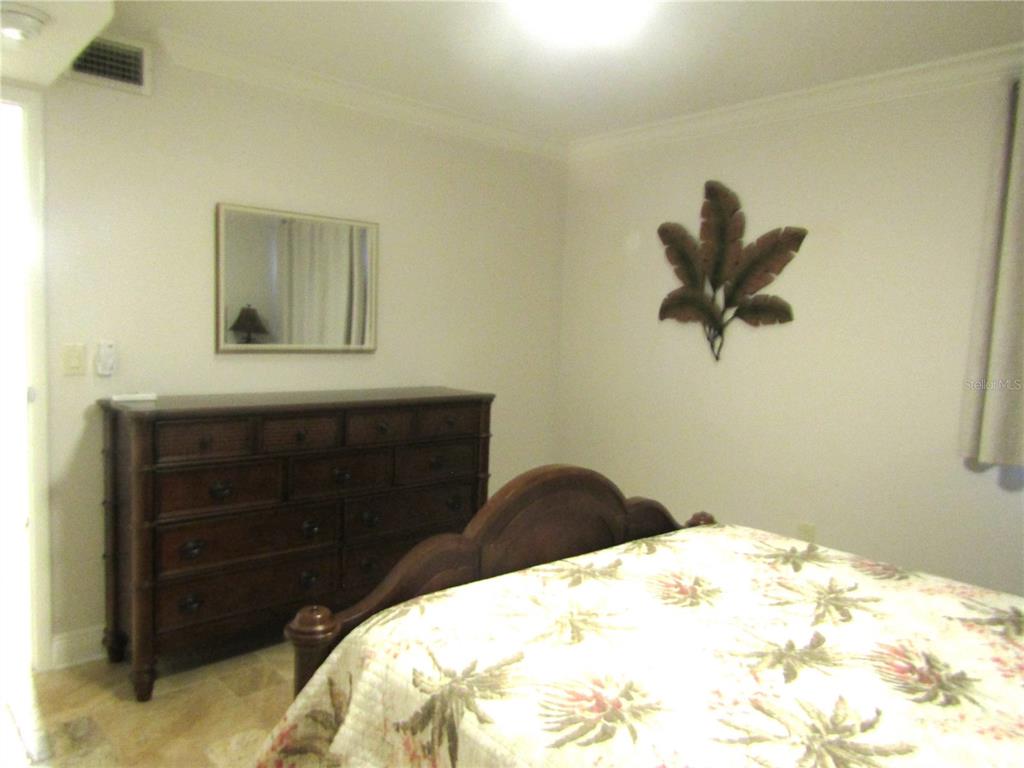 5056 Marsh Field Road, Unit 7 Sarasota, FL 34235 - Photo 21 of 31 a bedroom with a bed and a dresser