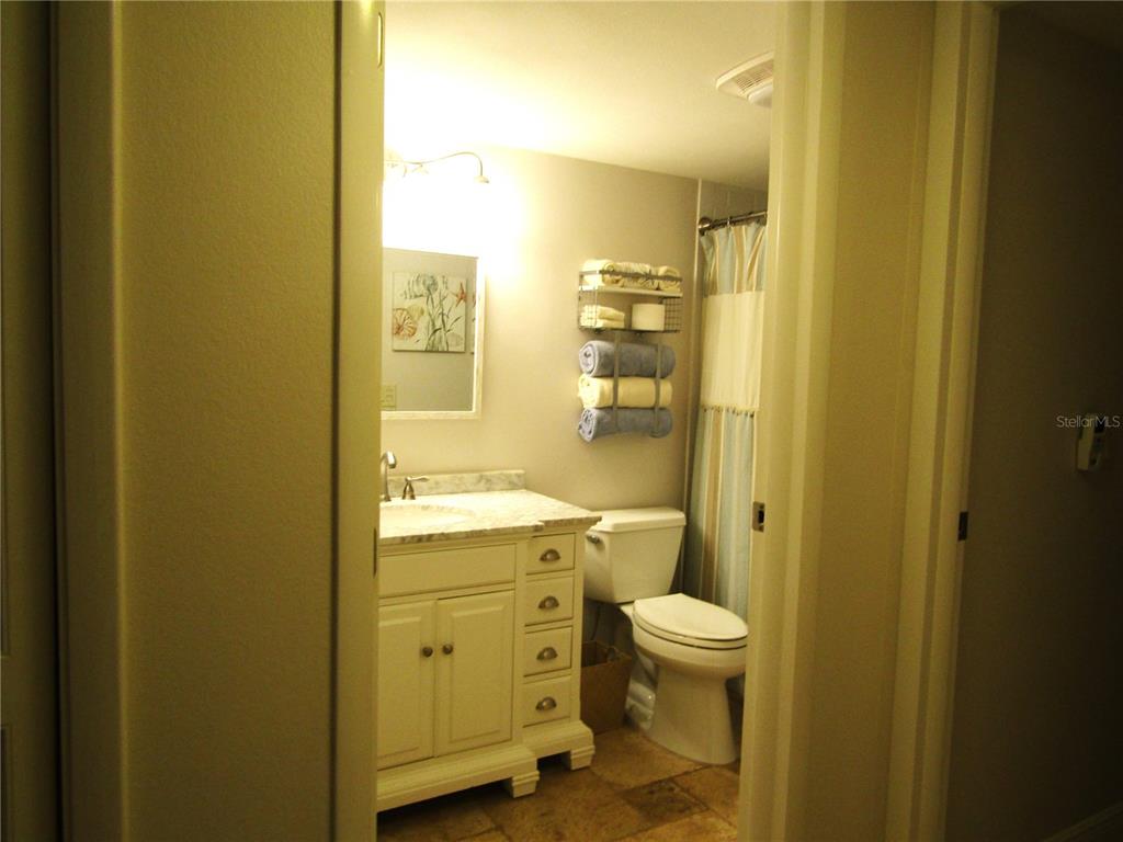 5056 Marsh Field Road, Unit 7 Sarasota, FL 34235 - Photo 22 of 31 a bathroom with a granite countertop sink a toilet and shower