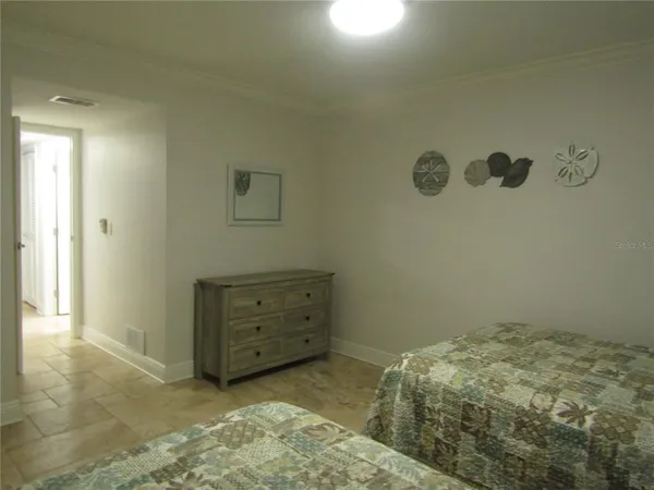 a bedroom with a bed and a dresser