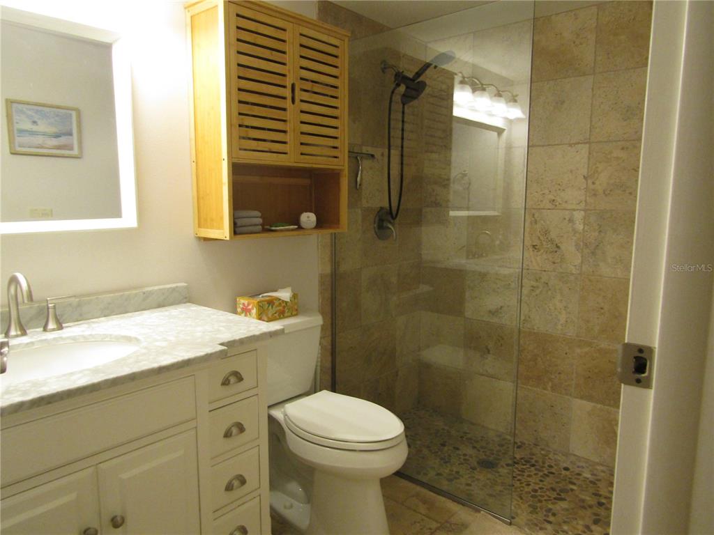 5056 Marsh Field Road, Unit 7 Sarasota, FL 34235 - Photo 26 of 31 a bathroom with a granite countertop sink toilet and shower
