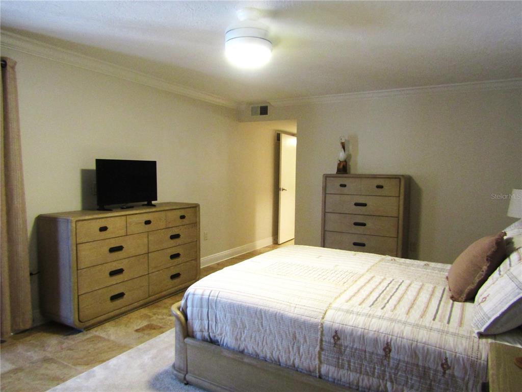 5056 Marsh Field Road, Unit 7 Sarasota, FL 34235 - Photo 29 of 31 a bedroom with a bed and television