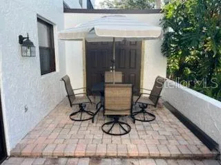 a view of patio with furniture and a potted plant