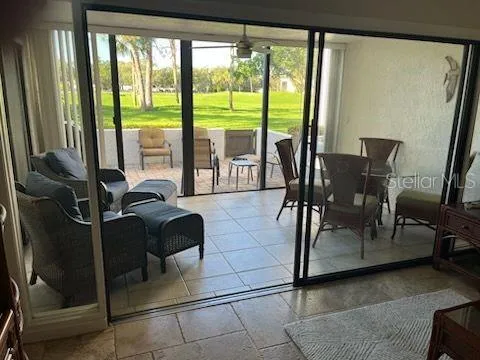 a living room with furniture and a floor to ceiling window