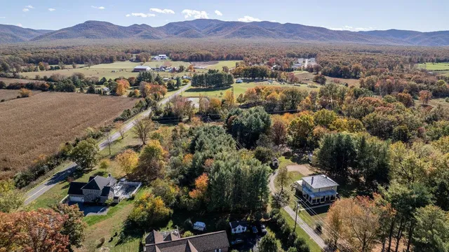 an aerial view of residential house and sandy dunes