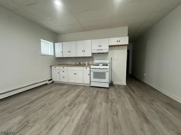 a view of a kitchen with stove and cabinets