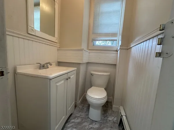 a bathroom with a toilet a sink and a window