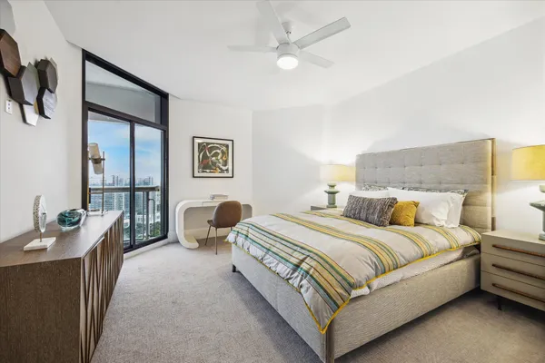 a bedroom with a bed and ceiling fan
