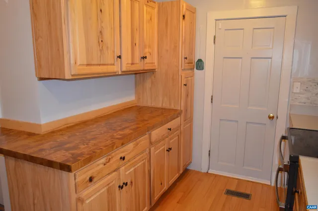 an empty room with wooden floor and a window