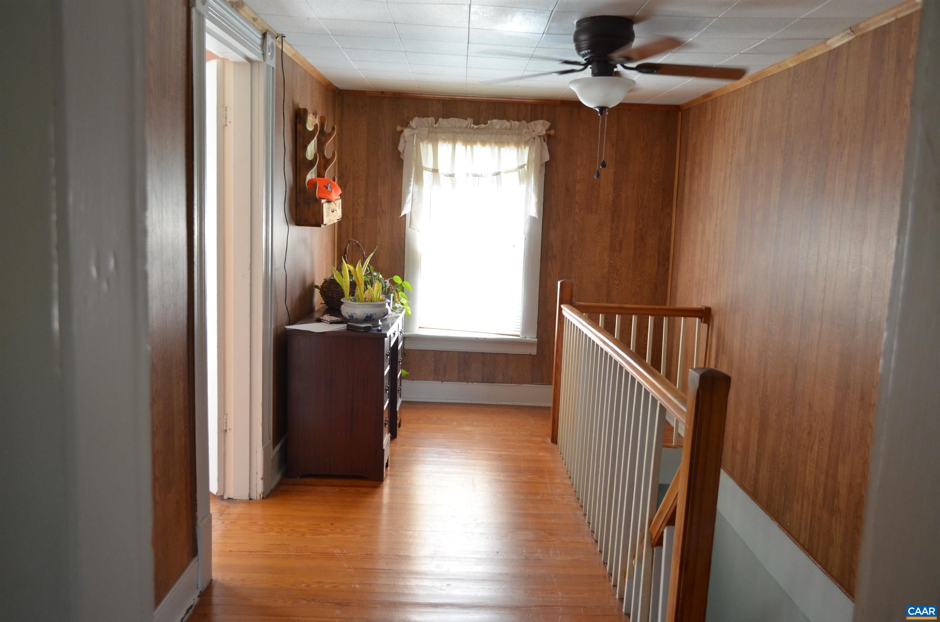10778 Rockfish River Road Shipman, VA 22971 - Photo 29 of 67 a view of a hallway with wooden floor and stairs